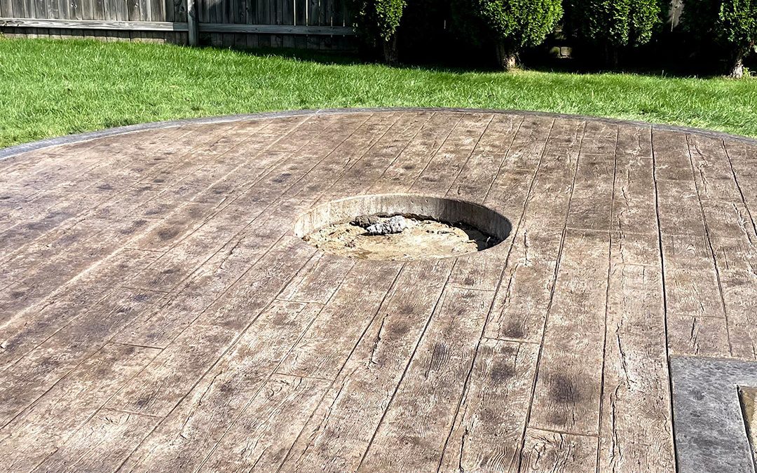 Stamped concrete patio transforming outdoor space by OAX Construction